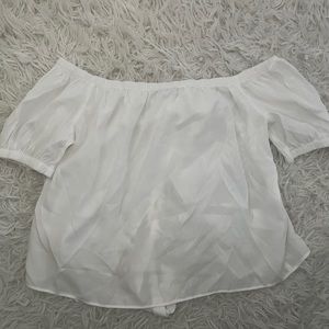 Short white shirt with an opening in the back as well as a cute tie in the back.